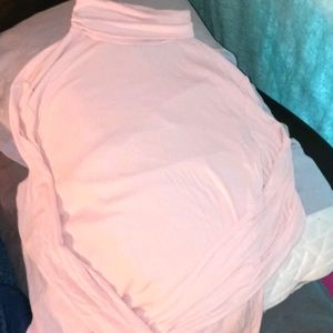 A pinkish/salmon colored longsleeve turtlneck